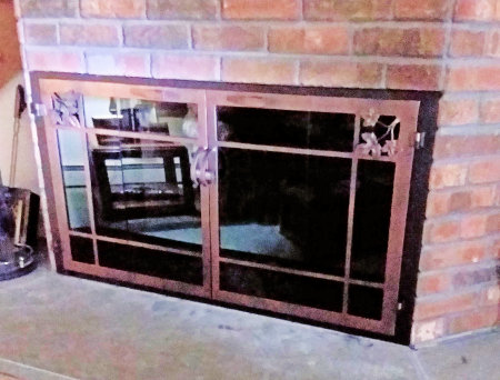 natures window black frame, with dark antique copper finish vice bi fold doors. Includes maple leaves in window pane design, smoked glass. Comes with slide mesh spark screens.